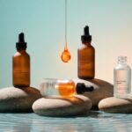 Koleksi serum BREVA premium: tiga botol skincare di atas batu alami dengan tetesan essence, menampilkan perawatan wajah untuk kulit sehat dan bercahaya.
